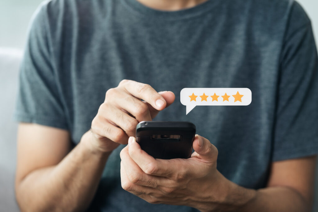 Close up of man customer giving a five star rating on smartphone